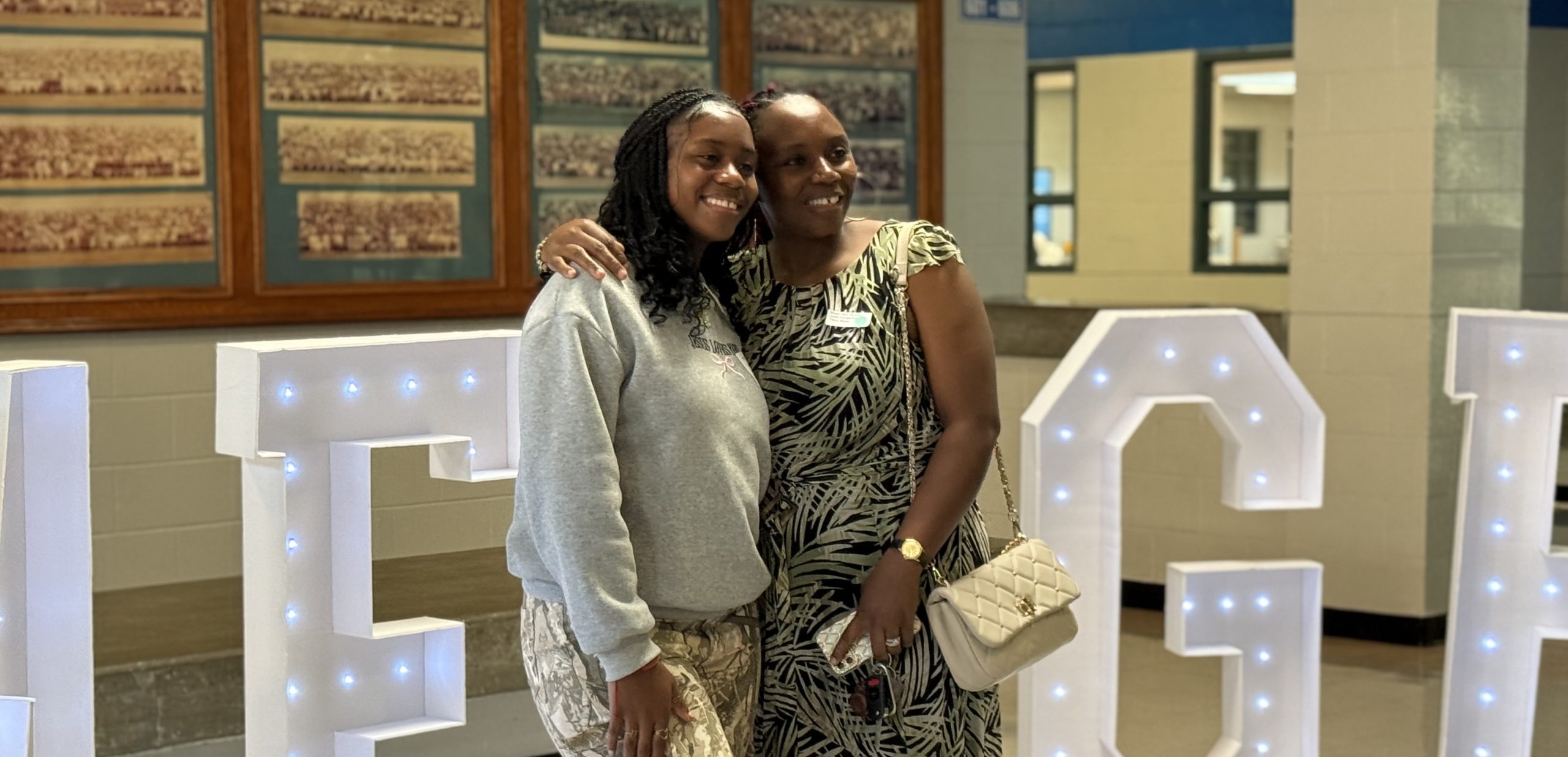 EMERGE scholar and mother posing at New Student Orientation